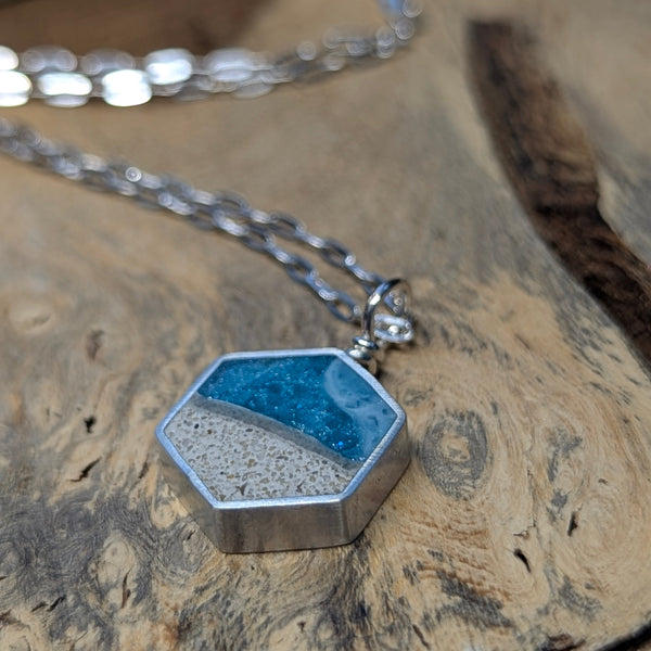 Hexagonal pendant necklace on a wooden surface